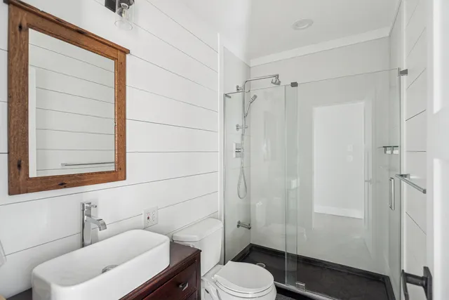 a bathroom with a toilet a sink and shower