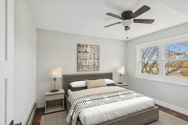 a bedroom with a large bed and a chandelier