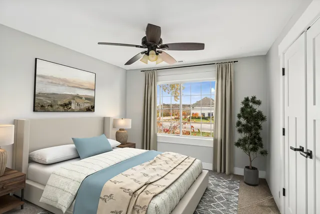 a bedroom with a bed and a painting on the wall