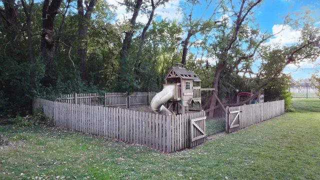 a view of a balcony with wooden floor and fence