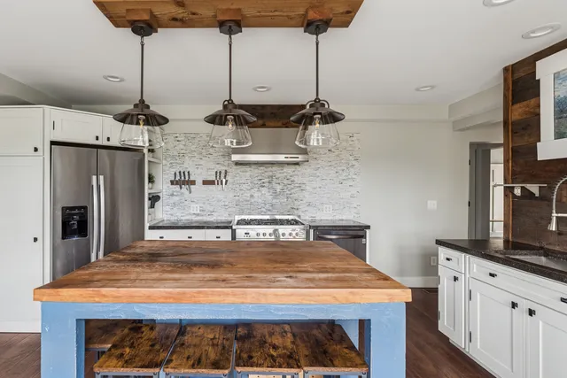 a kitchen with kitchen island a counter top space appliances and cabinets