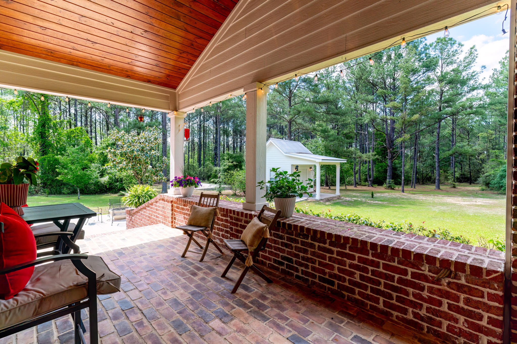 4351 Poverty Creek Road Crestview, FL 32539 - Photo 35 of 53 a view of a patio with chairs and floor to ceiling window