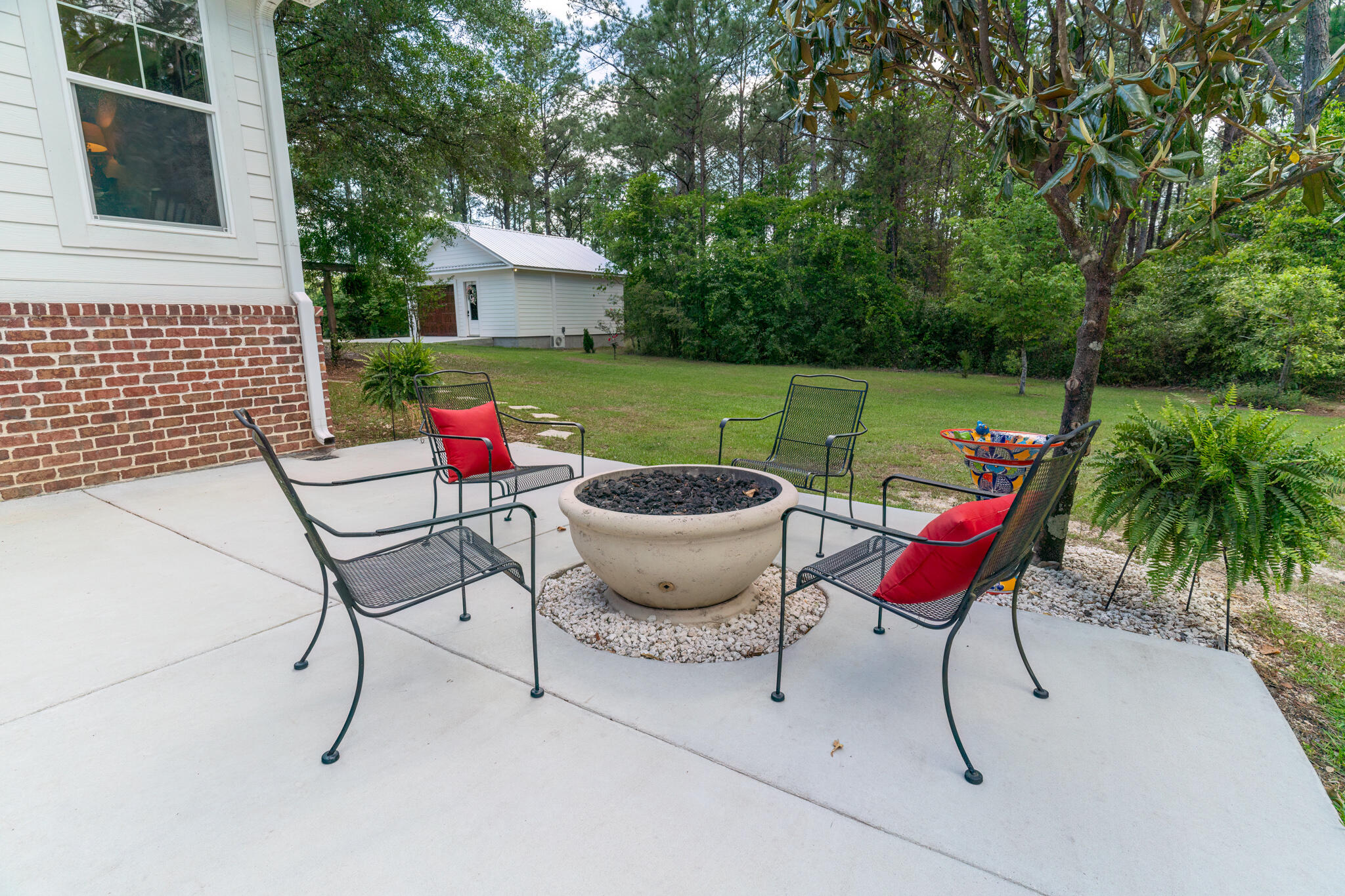 4351 Poverty Creek Road Crestview, FL 32539 - Photo 38 of 53 a backyard of a house with outdoor seating