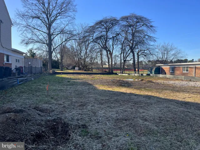 a backyard of apartments with large trees