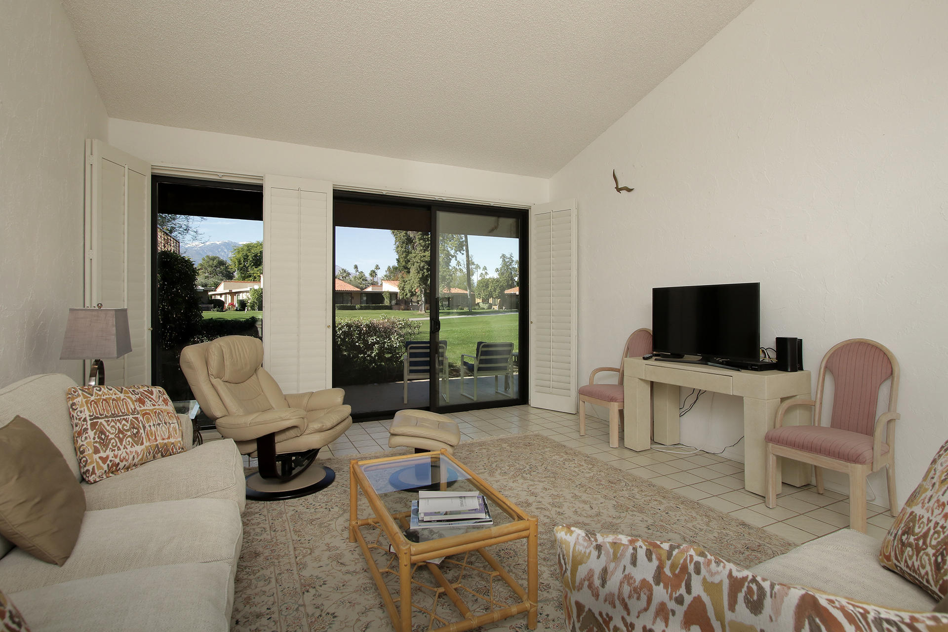 6 Cadiz Drive Rancho Mirage, CA 92270 - Photo 14 of 27 a living room with furniture a flat screen tv and a floor to ceiling window