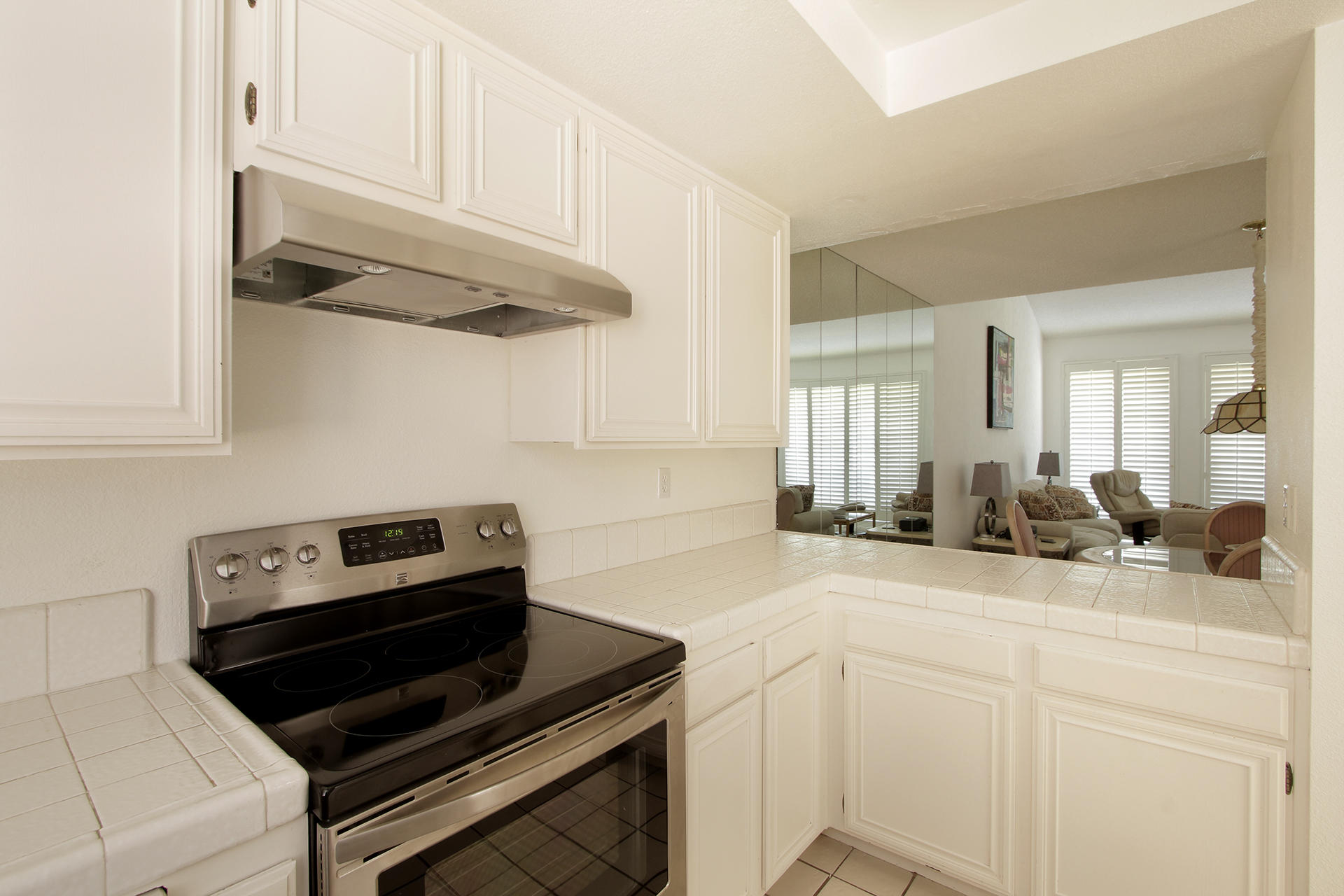6 Cadiz Drive Rancho Mirage, CA 92270 - Photo 18 of 27 a kitchen with white cabinets and a stove