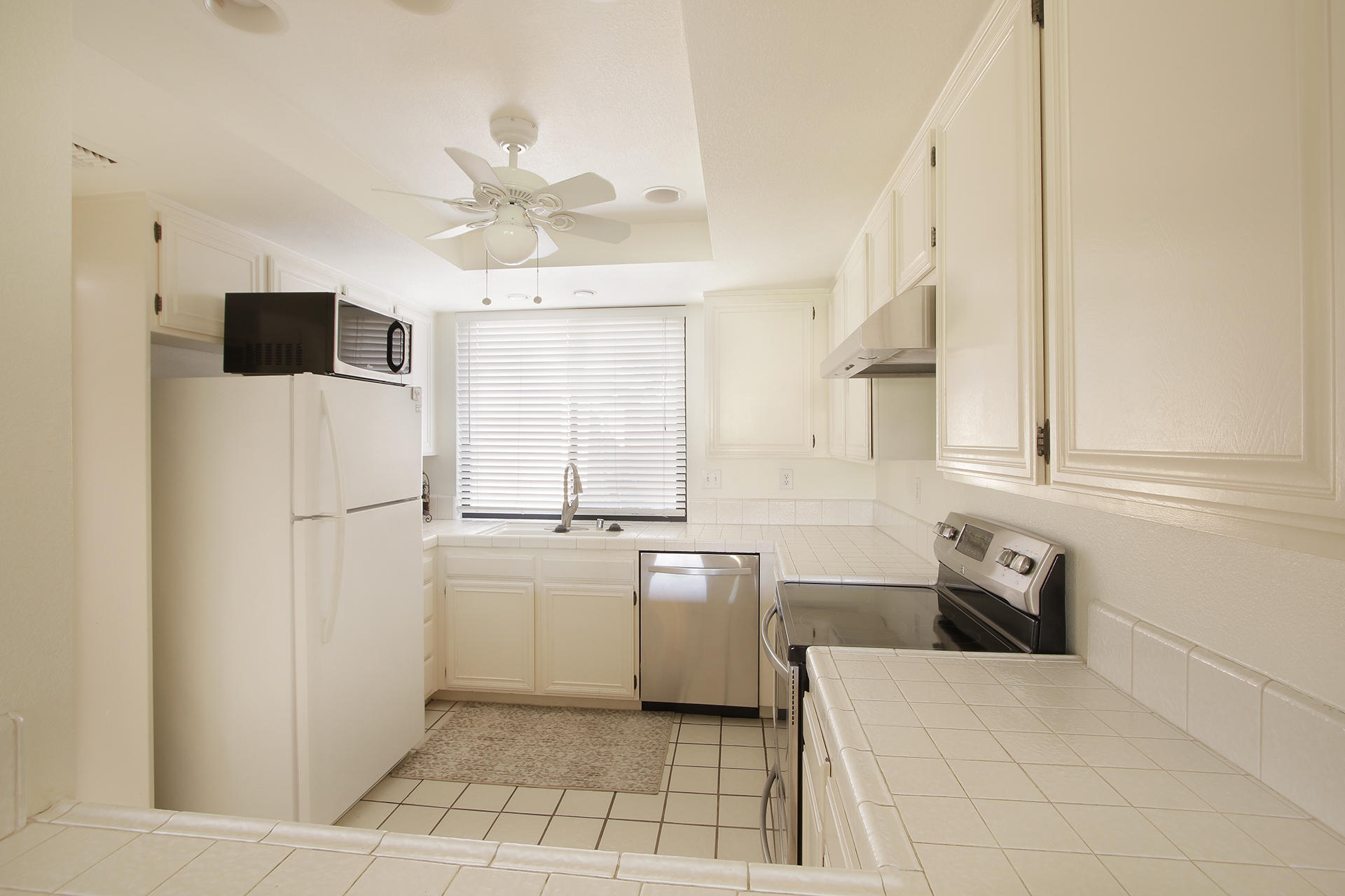 6 Cadiz Drive Rancho Mirage, CA 92270 - Photo 19 of 27 a kitchen with a refrigerator a sink and dishwasher