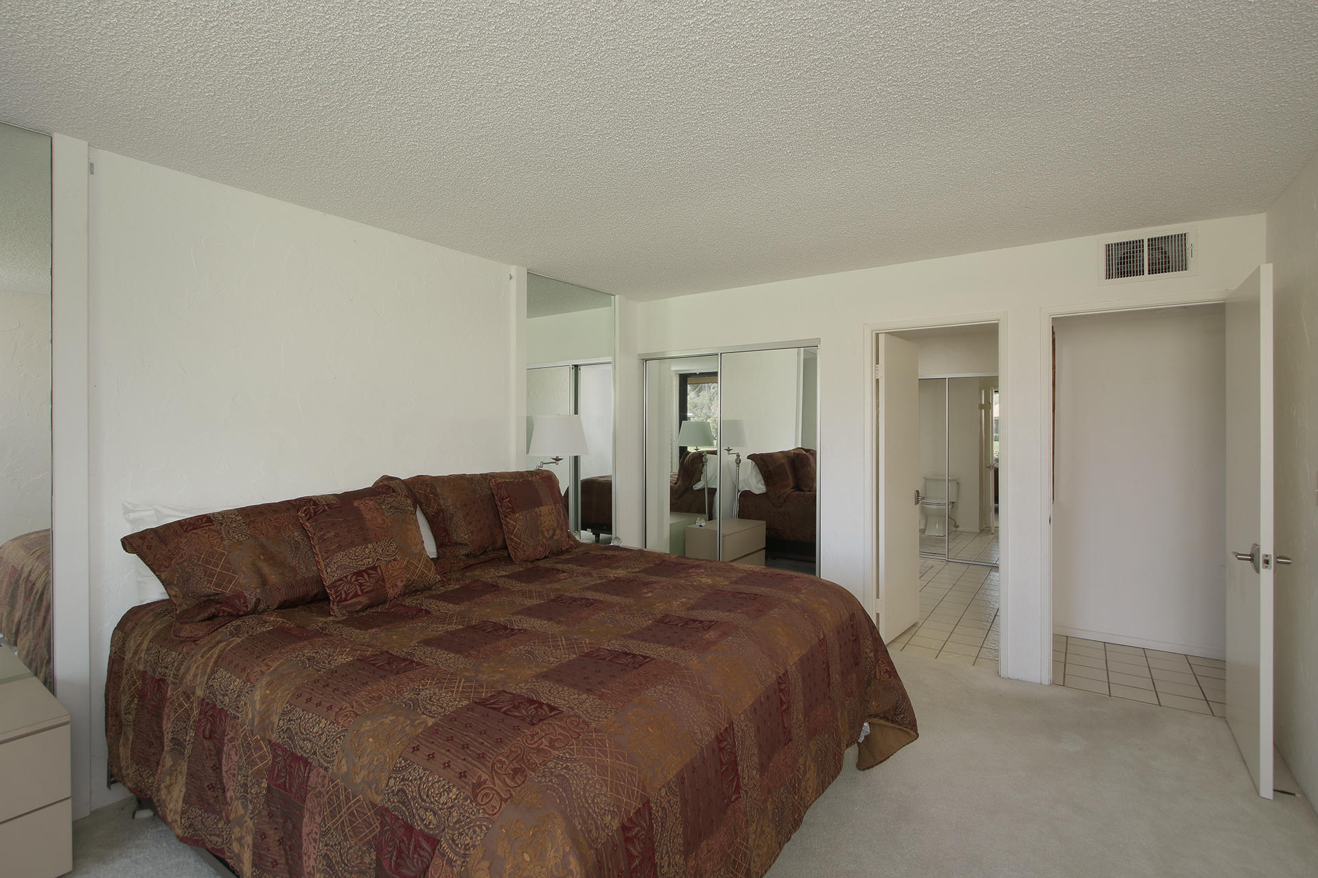 6 Cadiz Drive Rancho Mirage, CA 92270 - Photo 21 of 27 a large bed sitting in a bedroom and a table chair