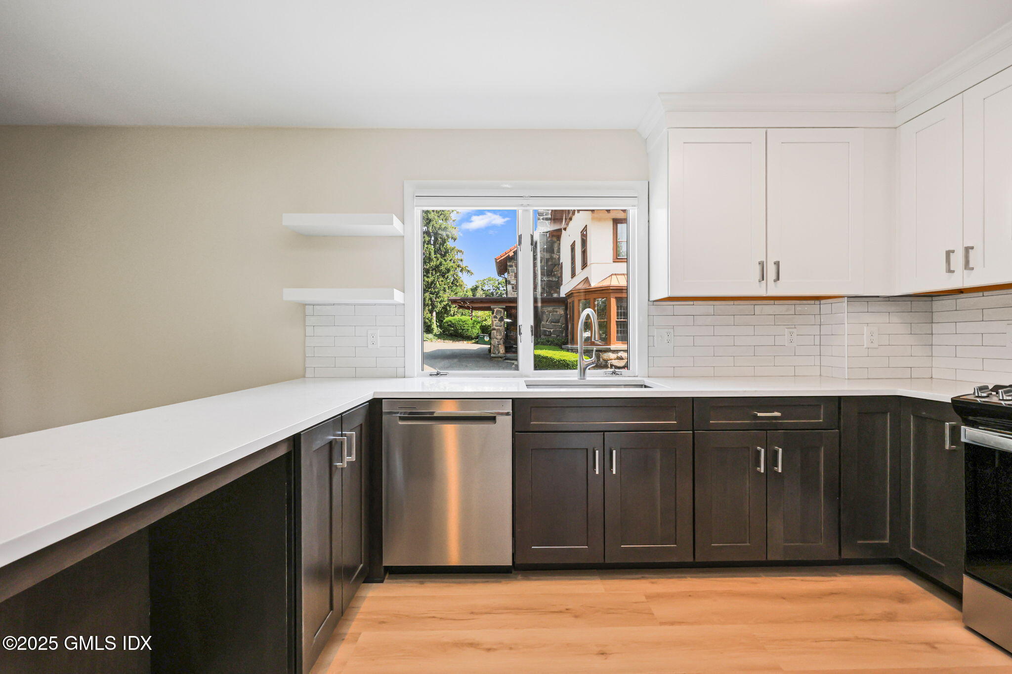 a kitchen with stainless steel appliances granite countertop a sink and wooden cabinets