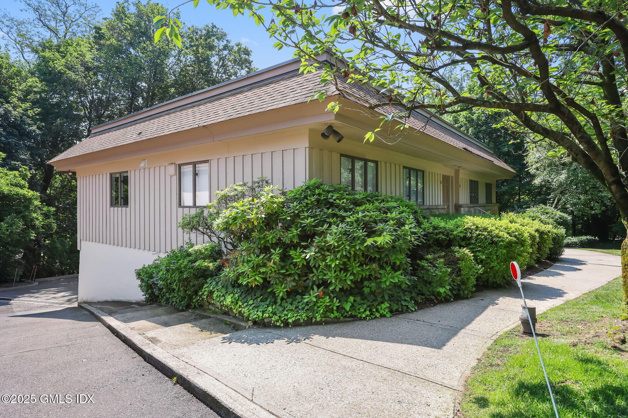 11 Maple Avenue, Unit 202 Greenwich, CT 06830 - Photo 17 of 18 a front view of a house with a yard and potted plants
