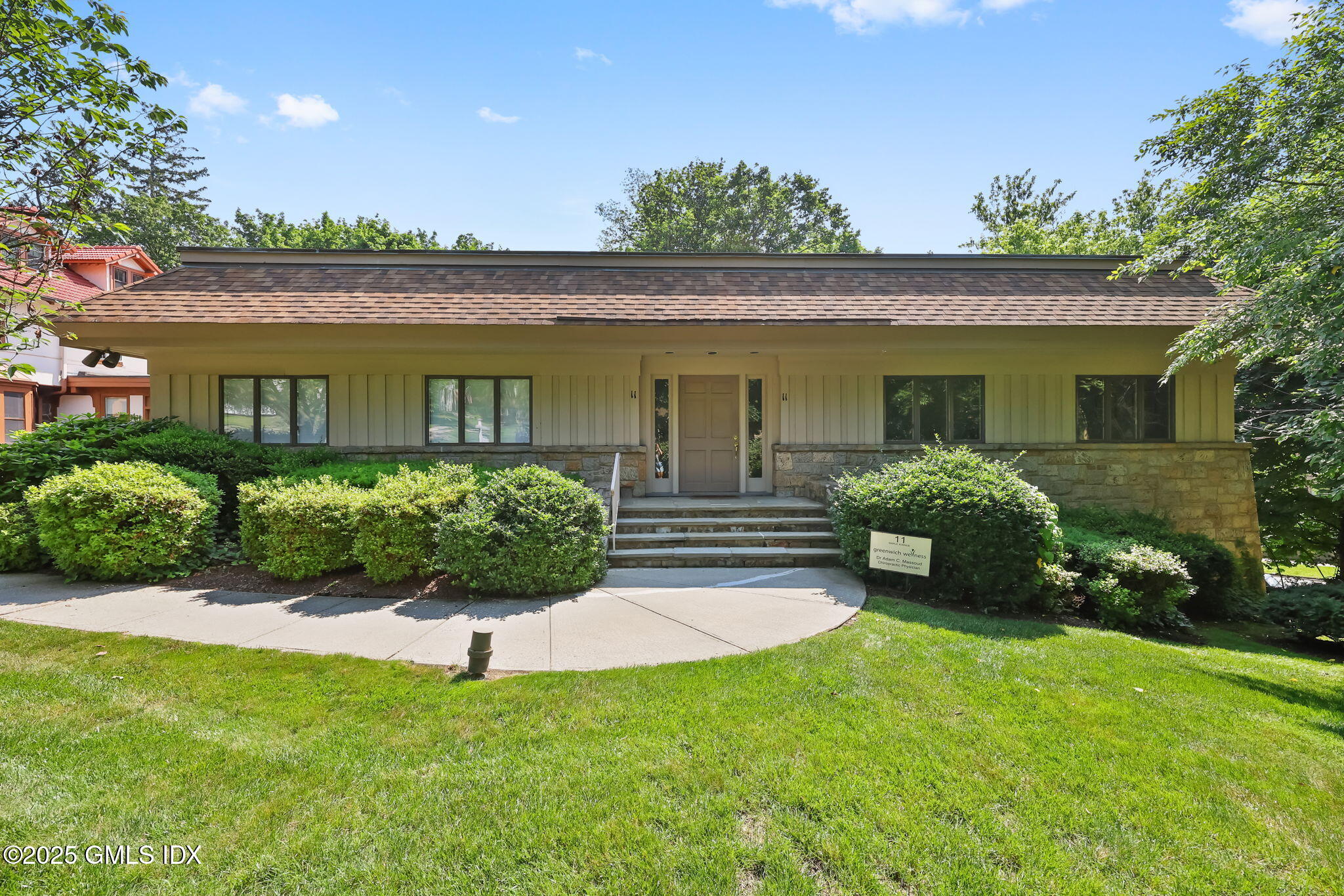 11 Maple Avenue, Unit 202 Greenwich, CT 06830 - Photo 2 of 18 front view of a house with a yard