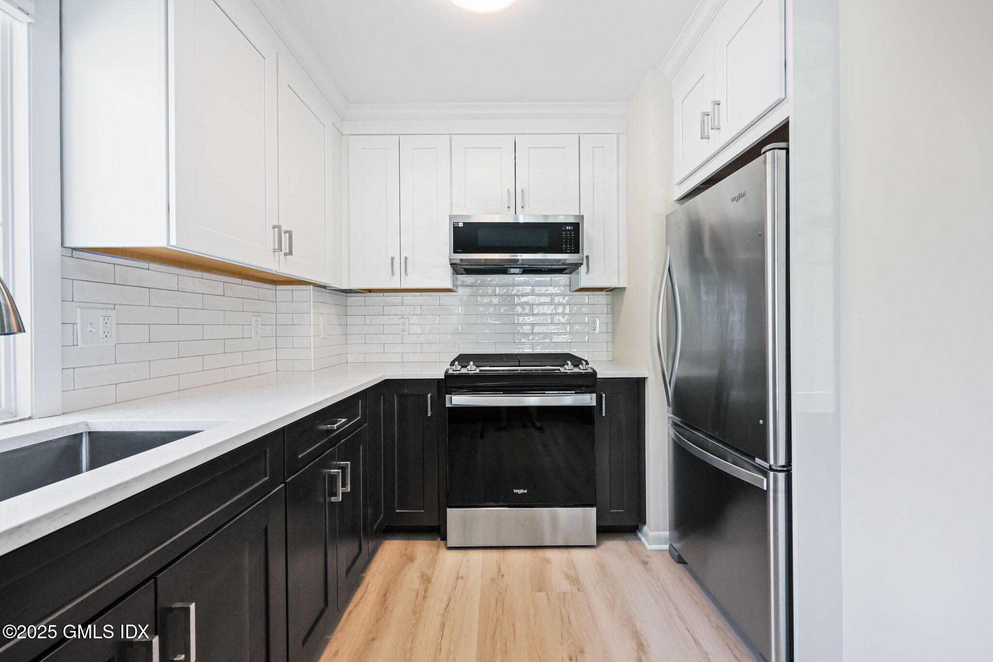 11 Maple Avenue, Unit 202 Greenwich, CT 06830 - Photo 7 of 18 a kitchen with a sink and stainless steel appliances