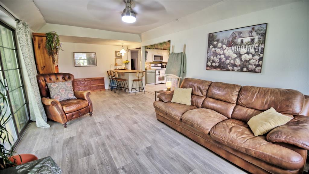 140 Elm Road Nocona, TX 76255 - Photo 6 of 26 a living room with furniture and a wooden floor