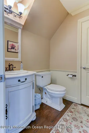 a bathroom with a toilet a sink and mirror