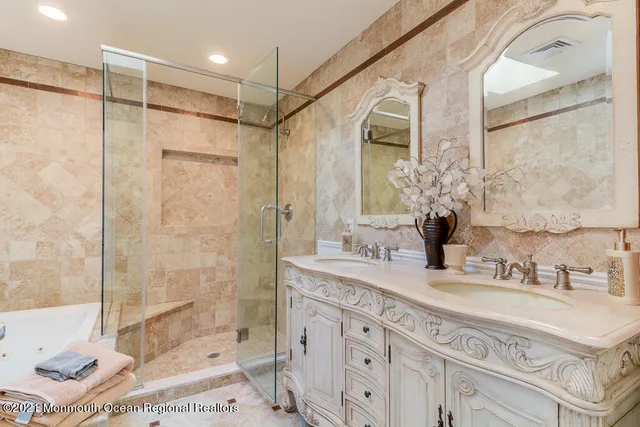 a bathroom with a granite countertop sink mirror and a shower