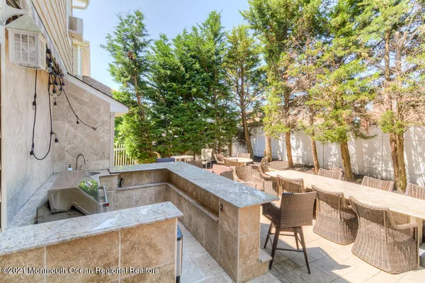 a view of a patio with table and chairs
