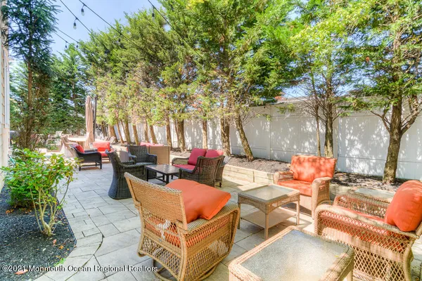 a kitchen with stainless steel appliances kitchen island granite countertop a table chairs sink and cabinets