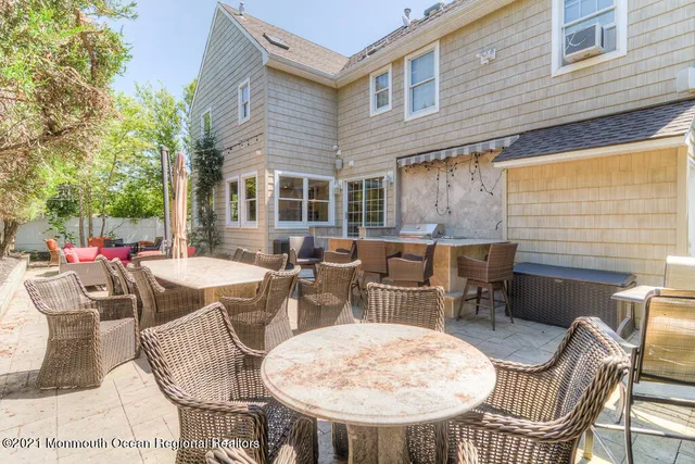 a view of a patio with couches chairs and a fire pit