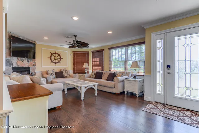 a living room with fireplace furniture and a large window