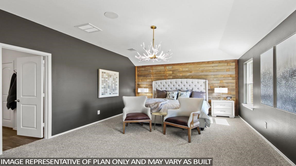 4265 Multnomah Falls Drive Conroe, TX 77303 - Photo 7 of 20 a bed room with a bed and a chandelier