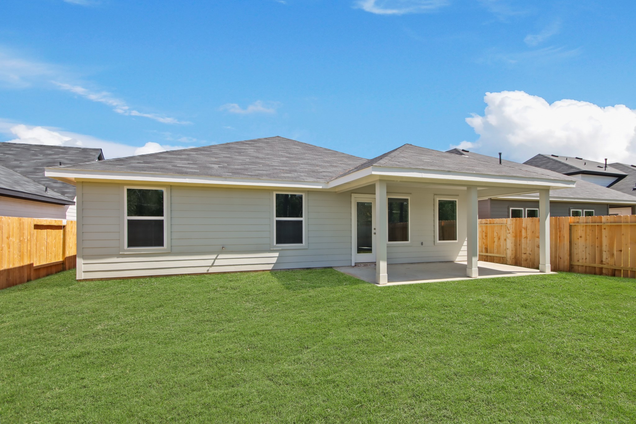 4265 Multnomah Falls Drive Conroe, TX 77303 - Photo 8 of 20 a front view of a house with a garden and yard