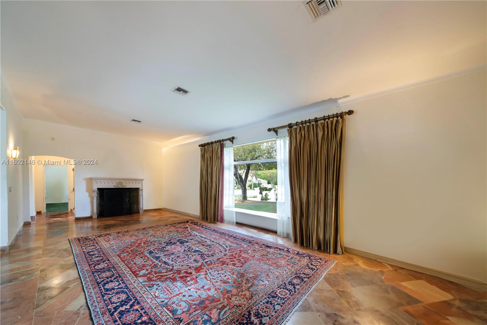 5801 Alton Road Miami Beach, FL 33140 - Photo 11 of 35 a bedroom with a bed and a fireplace