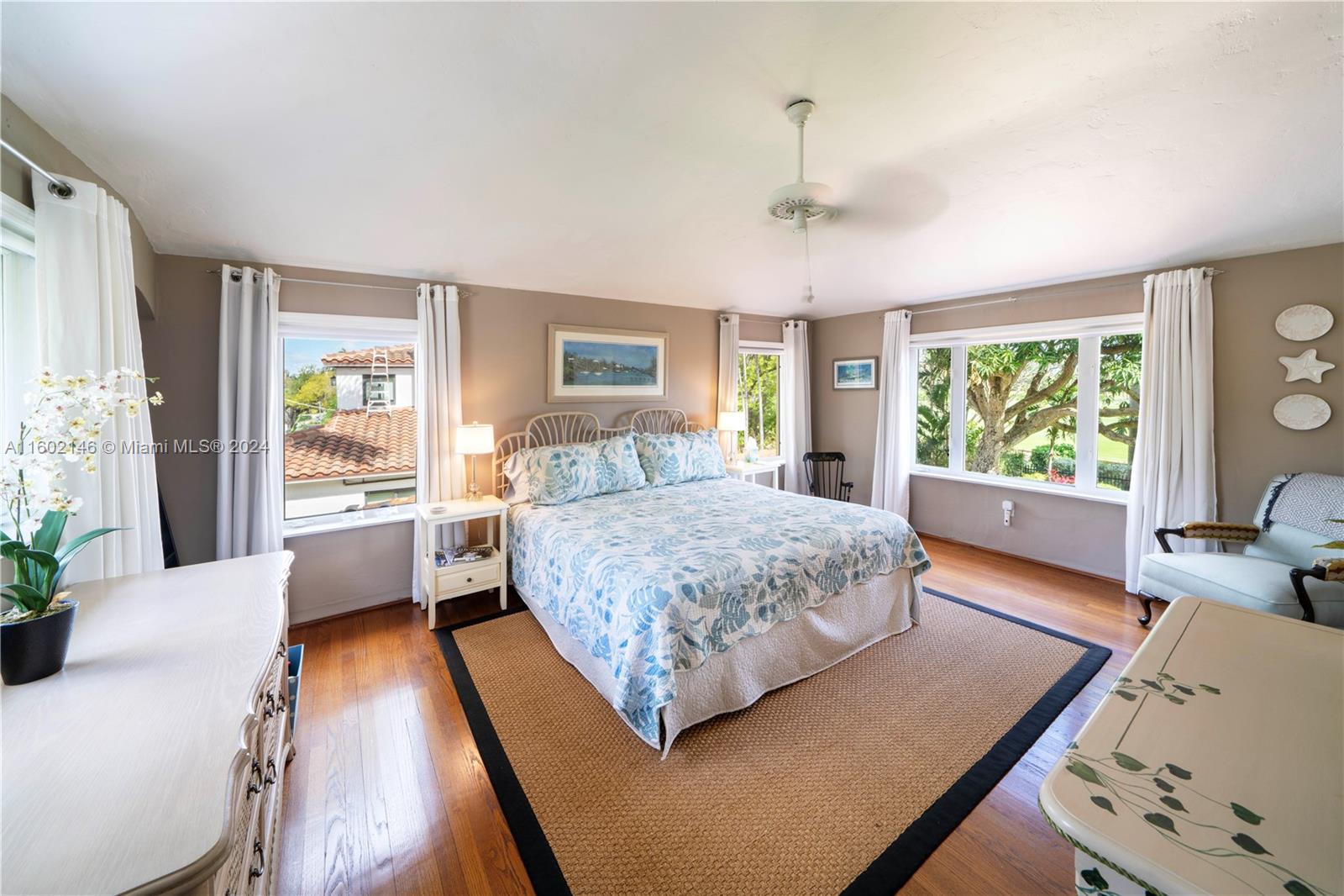 5801 Alton Road Miami Beach, FL 33140 - Photo 18 of 35 a bedroom with a large bed and a large window