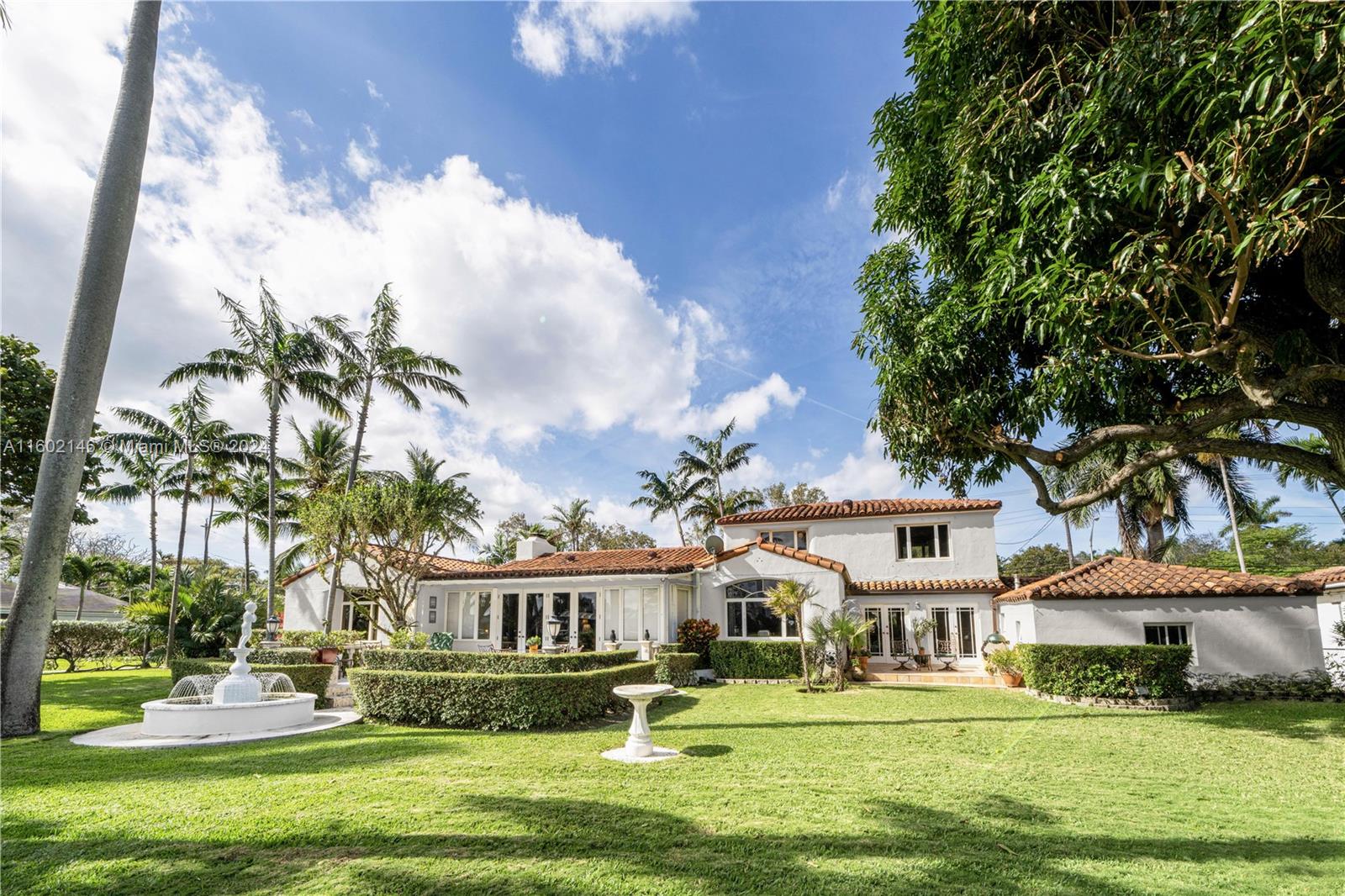 5801 Alton Road Miami Beach, FL 33140 - Photo 3 of 35 a front view of a residential houses with yard and green space