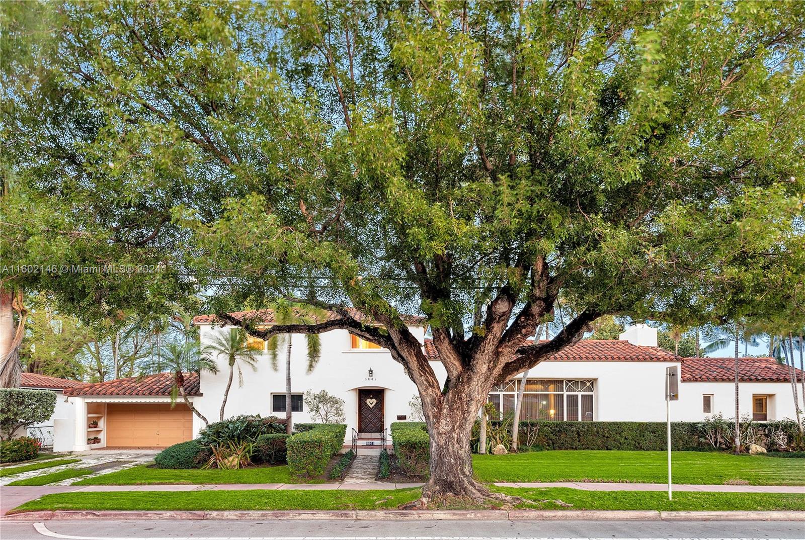 5801 Alton Road Miami Beach, FL 33140 - Photo 8 of 35 a tree in front of a white house