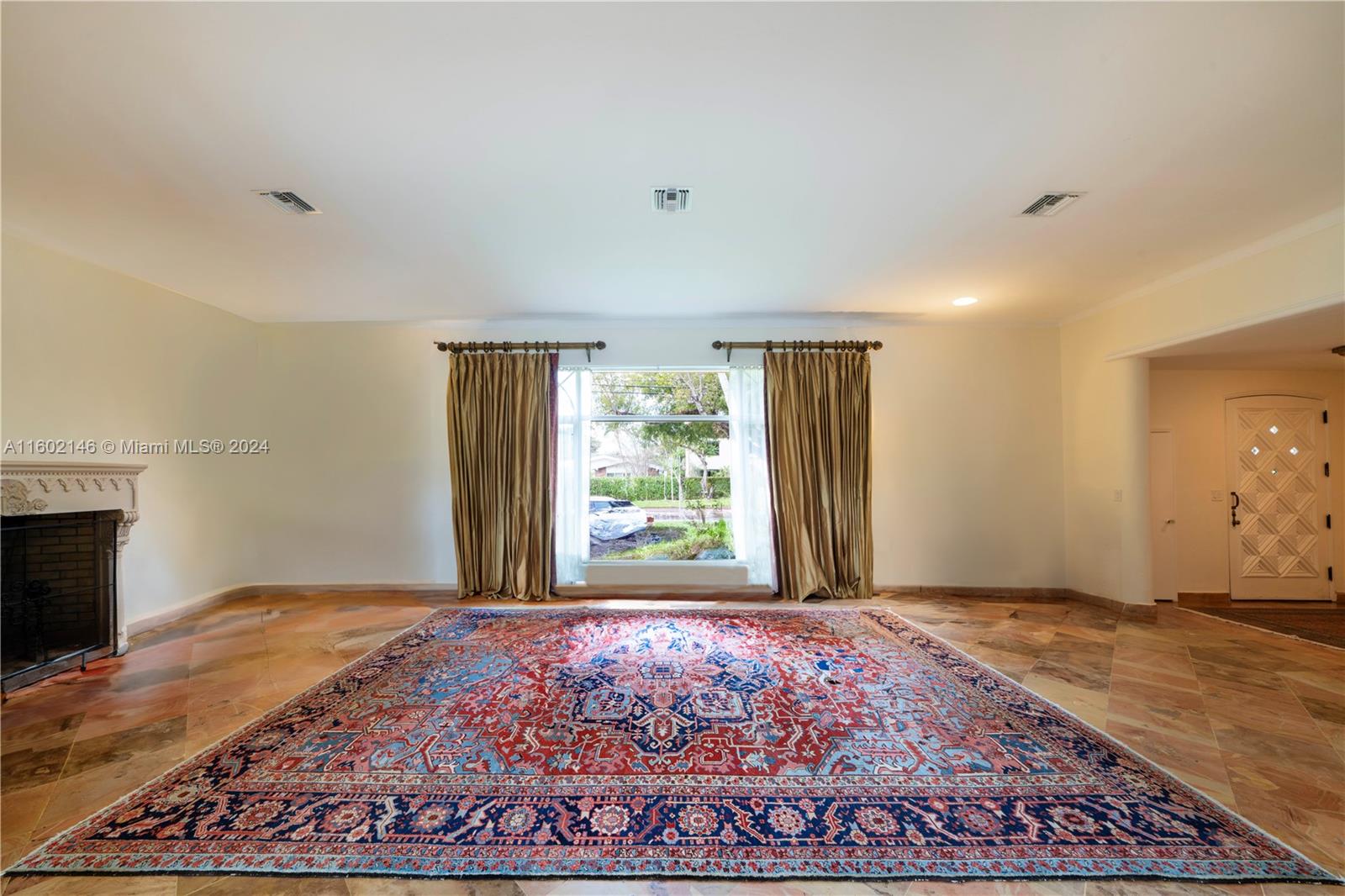 5801 Alton Road Miami Beach, FL 33140 - Photo 10 of 35 a view of an empty room with wooden floor and a window