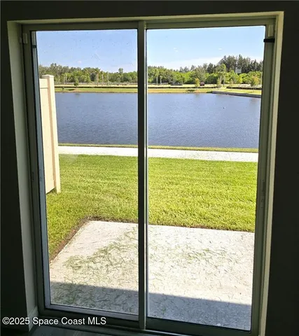 a view of yard with swimming pool and trees in the background