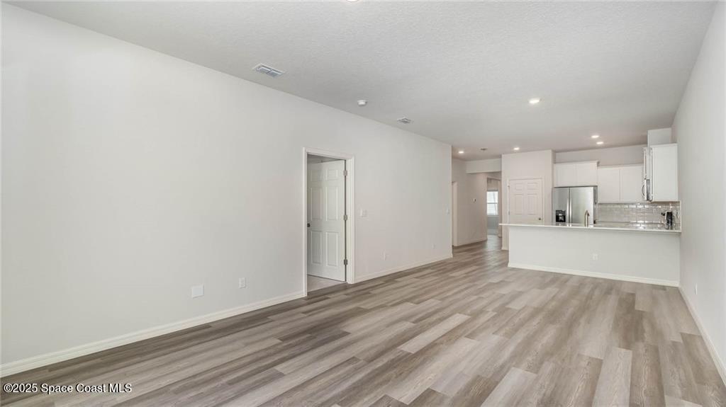 9036 Orchid Reserve Circle Sebastian, FL 32958 - Photo 5 of 25 a view of a kitchen with wooden floor