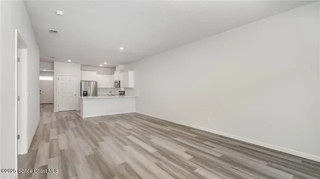 a view of kitchen with wooden floor