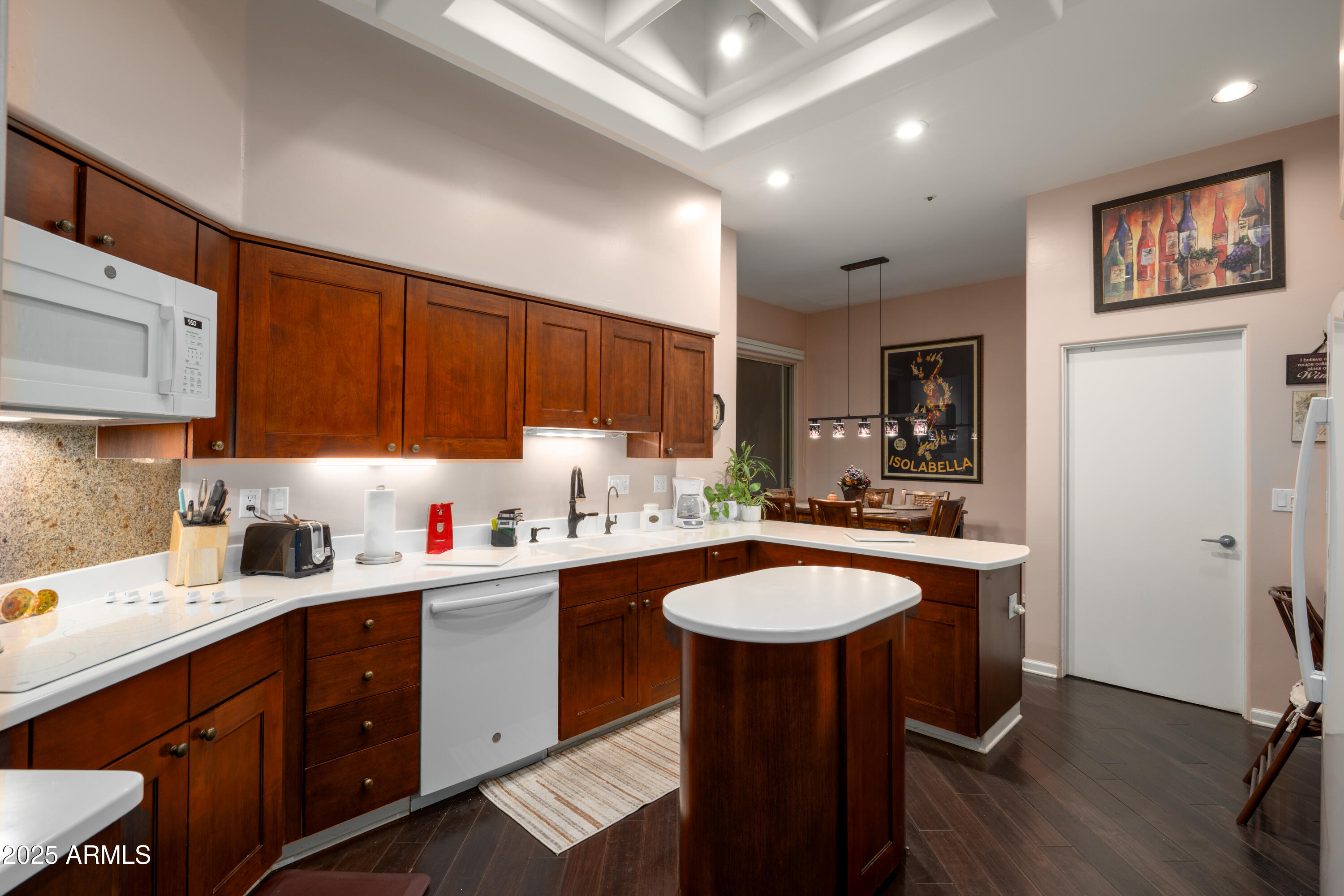 6711 East Camelback Road, Unit 21 Scottsdale, AZ 85251 - Photo 19 of 33 a kitchen with a sink a cabinets and chairs