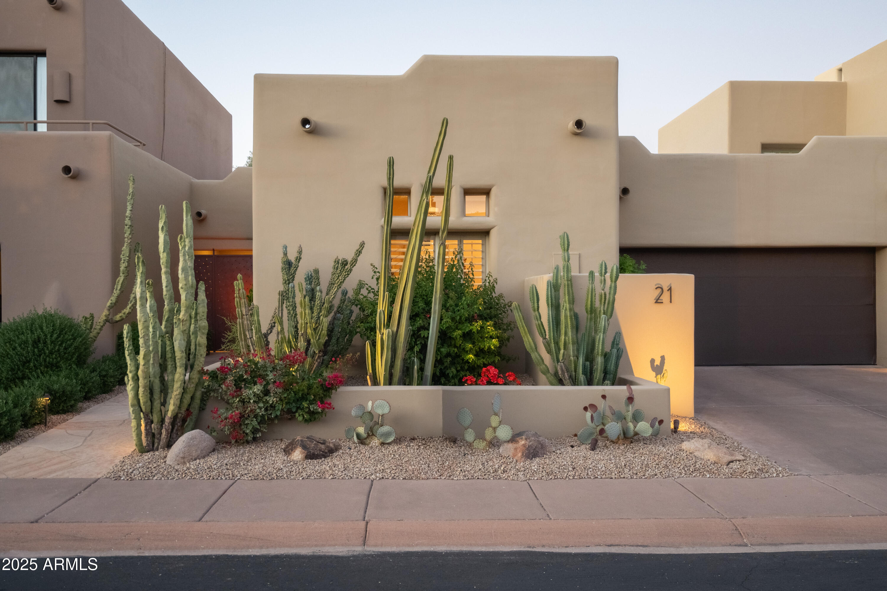 6711 East Camelback Road, Unit 21 Scottsdale, AZ 85251 - Photo 2 of 33 a front view of a building with garden