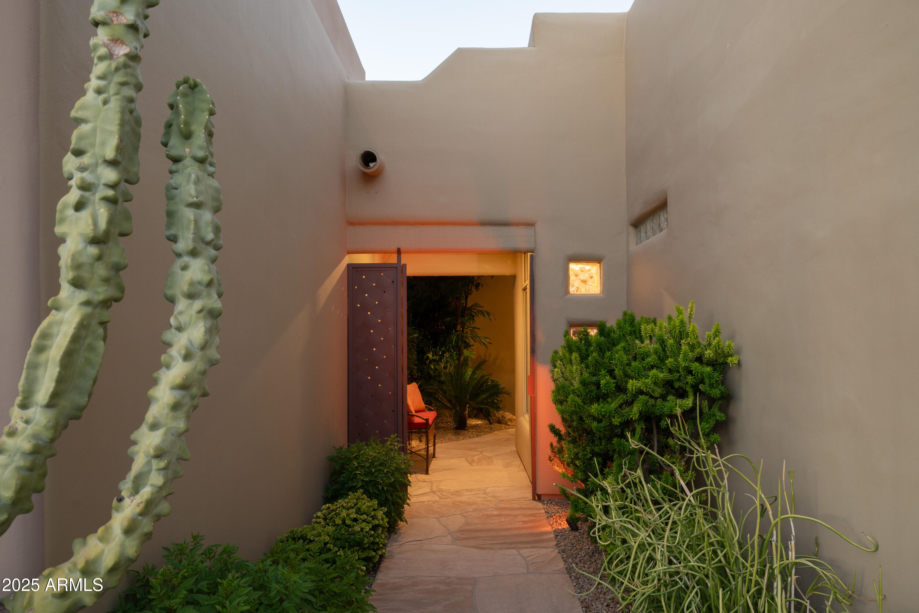 6711 East Camelback Road, Unit 21 Scottsdale, AZ 85251 - Photo 3 of 33 a front view of a house with a yard