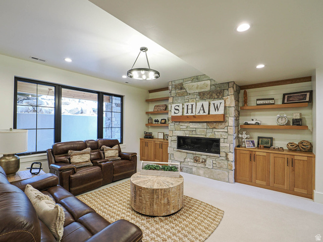 3167 South Mapleton Estates Drive Mapleton, UT 84664 - Photo 15 of 42 Living area featuring light carpet, a stone fireplace, and recessed lighting