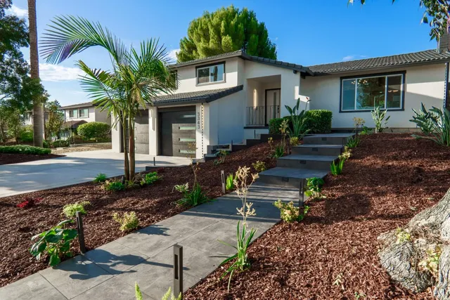a living room with furniture a chandelier and a flat screen tv