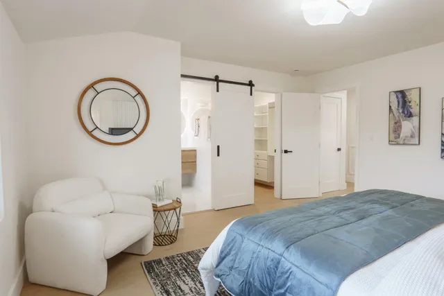 a bedroom with a bed and a chandelier