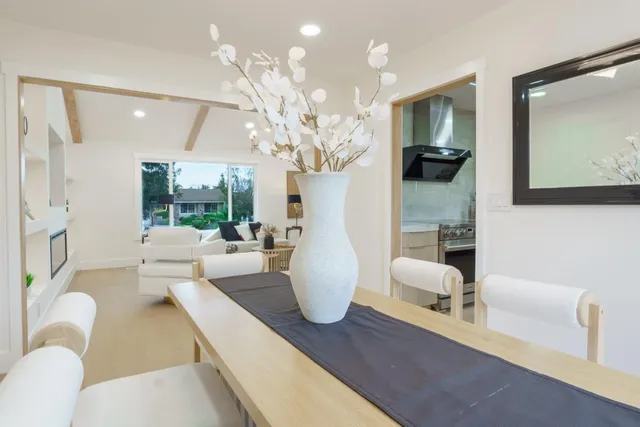 a bench sitting in front of a house with wooden fence