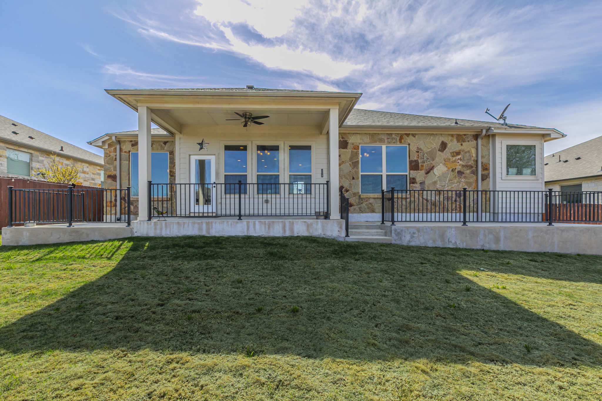 300 Magan Lane Jarrell, TX 76537 - Photo 27 of 33 Back of house with ceiling fan, a patio, and stone siding