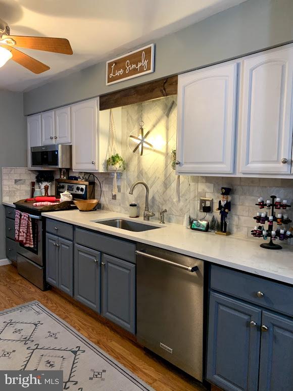 404 Mitti Road Reading, PA 19607 - Photo 11 of 37 a kitchen with stainless steel appliances granite countertop a sink dishwasher a stove and a microwave oven with cabinets