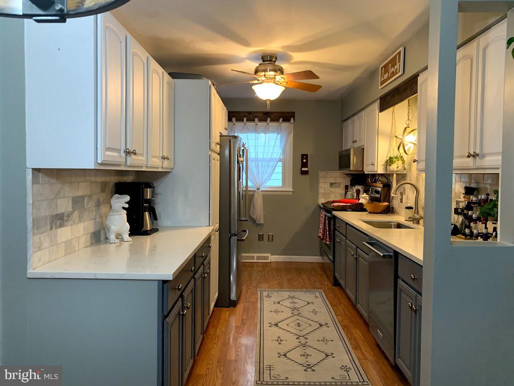 404 Mitti Road Reading, PA 19607 - Photo 9 of 37 a kitchen with kitchen island granite countertop a sink stainless steel appliances cabinets and a counter top space