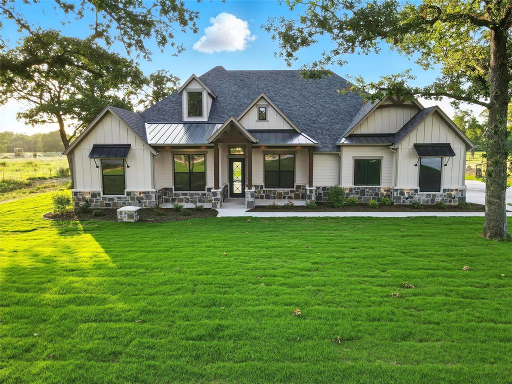 165 Rio Rancho Drive Decatur, TX 76234 - Photo 1 of 1 Modern inspired farmhouse featuring board and batten siding, a standing seam roof, and roof with shingles