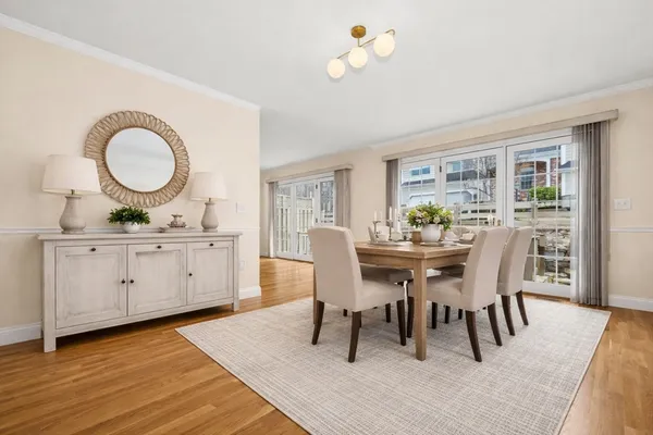 a view of a dining room with furniture and wooden floor
