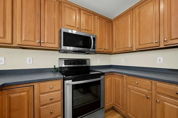 a kitchen with granite countertop cabinets stainless steel appliances and sink