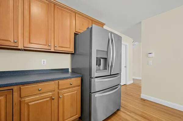 a kitchen with stainless steel appliances granite countertop a refrigerator and cabinets