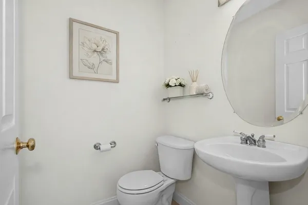 a bathroom with a sink mirror and toilet