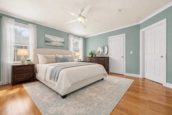a bedroom with a large bed and a chandelier