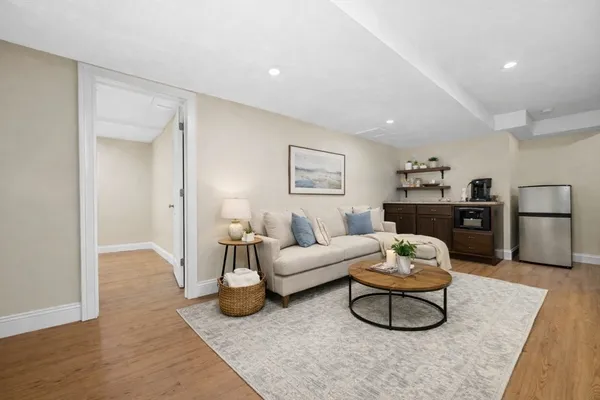 a view of an empty room with wooden floor and closet